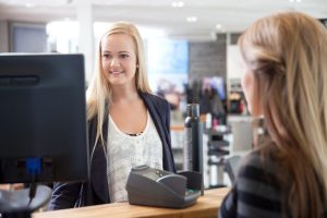 Receptionist Helping Customer at Beauty Salon